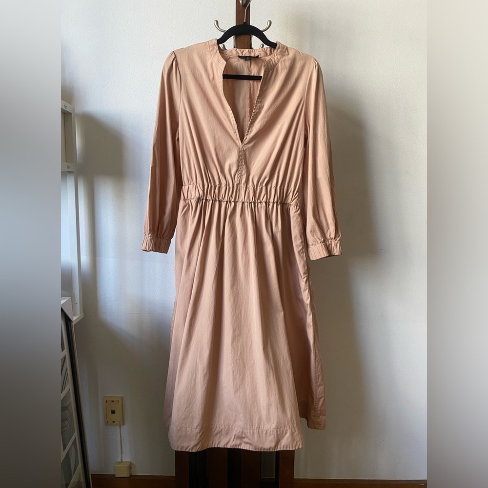 Pink long sleeve dress with deep V cut and cinched waist